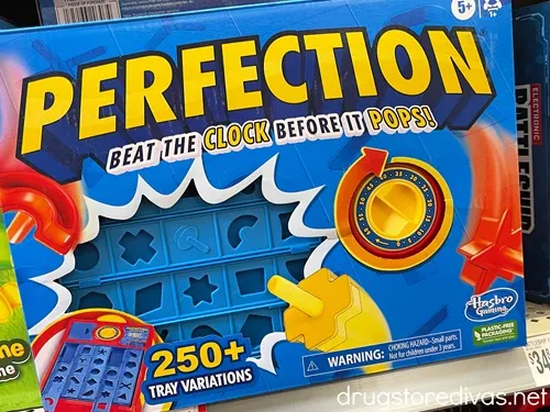 A Perfection board game on a shelf.