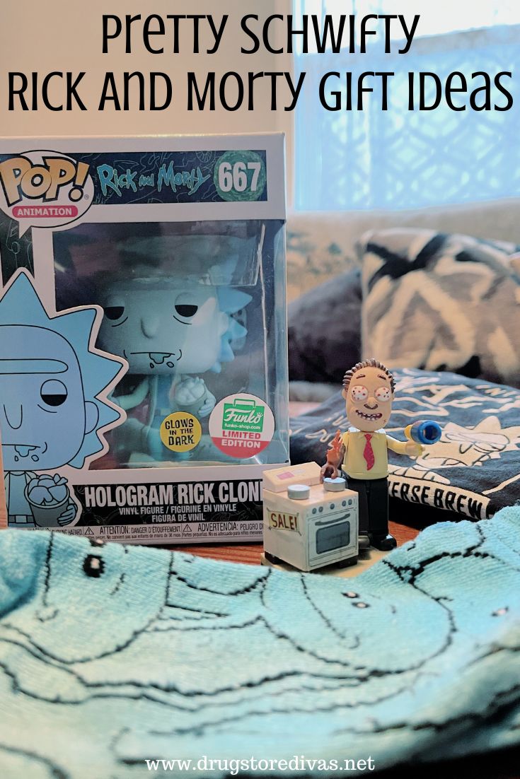 A Funko Pop, black shirt, blue socks, and a small action figure on a table with the words 