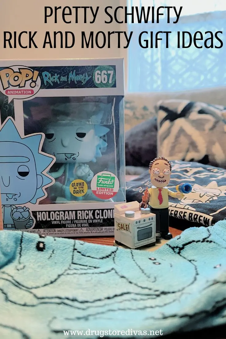 A Funko Pop, black shirt, blue socks, and a small action figure on a table with the words 