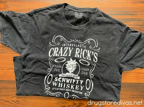 A black t-shirt with an image of Rick from the cartoon Rick & Morty and some words on it.