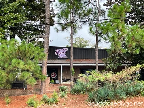 A building behind trees that says "Southern Pines Brewing Company on Pennsylvania" on it.