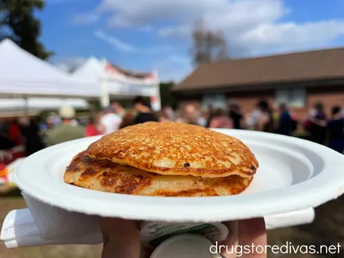 Potato pancakes on a Styrofoam plate.