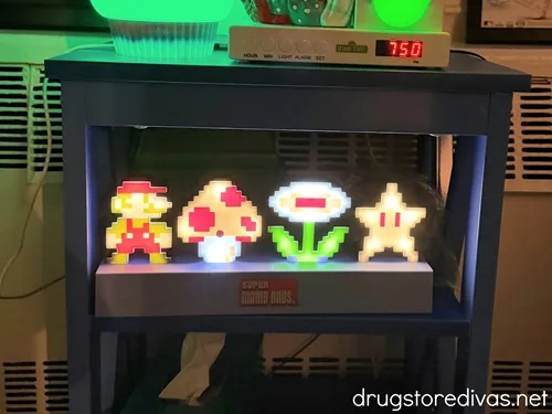 A Super Mario Bros Icon Light lit up in a bedroom.