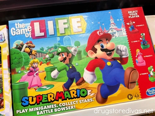 A Super Mario-themed Game of Life board game on a shelf in a store.