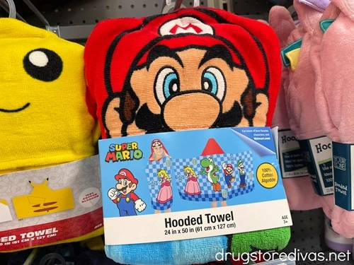 A Super Mario hooded towel on a shelf in a store.