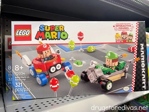 A Super Mario Mariokart Lego set on a shelf in a store.