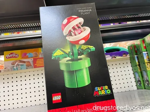 A Super Mario Pirahna Plant LEGO kit in a box on a shelf in a store.