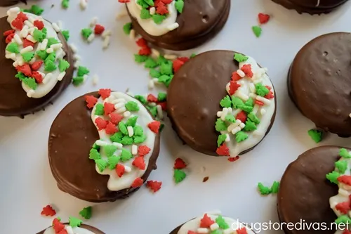 A bunch of Chocolate-Covered Christmas Oreo Cookies on a white tray.