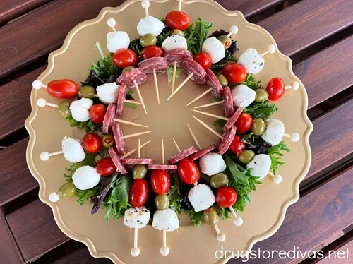 A Christmas Wreath Charcuterie Board on a brown table.