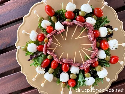 A Christmas Wreath Charcuterie Board on a brown table.
