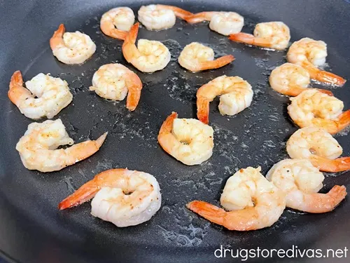 Cooked shrimp in a skillet.