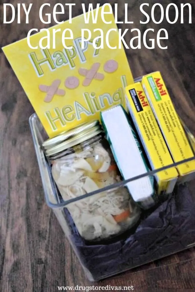A plastic box filled with a mason jar of soup, tissues, two boxes of medication, and a happy healing card in the back with the words "DIY Get Well Soon Care Package" digitally written on the top.