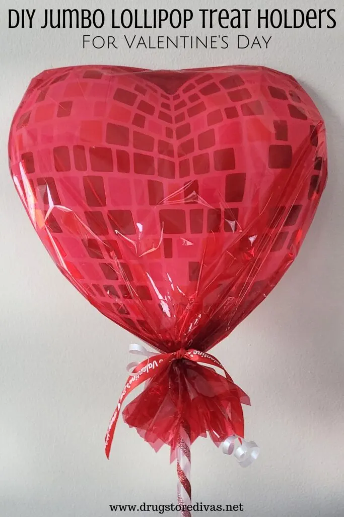 A giant red lollipop with the words "DIY Jumbo Lollipop Treat Holders For Valentine's Day" digitally written on top.