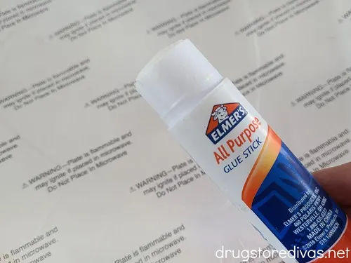 An Elmer's glue stick above a plate.