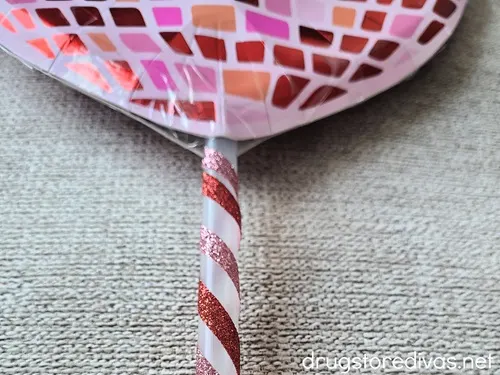 A heart-shaped disco ball-looking plate with a straw at the bottom.