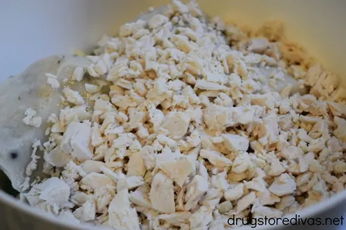 Chopped chicken in a white bowl.