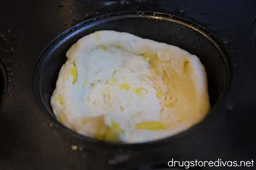 Biscuit dough in a muffin tin.