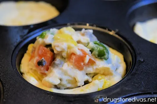 Unbaked mini chicken pot pies in a muffin tin.