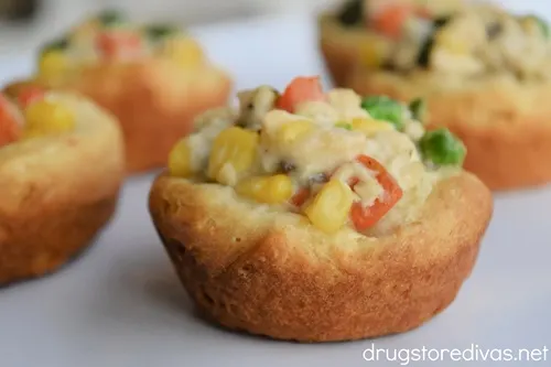 Mini chicken pot pies on a white tray.