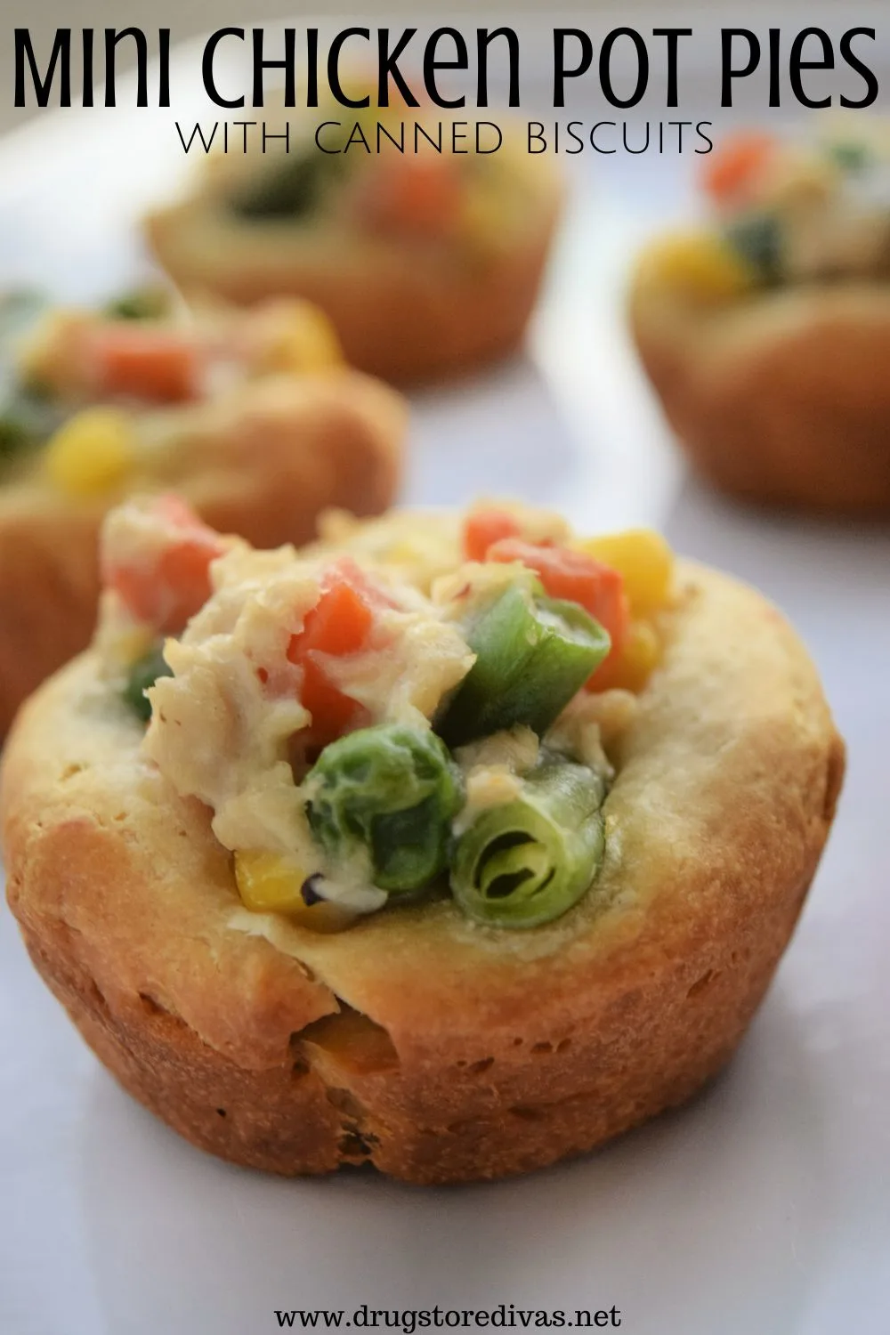 A bunch of mini chicken pot pies on a white tray with the words 