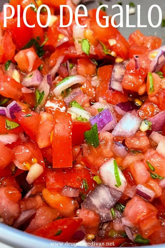 Chopped tomatoes, red onions, and cilantro in a bowl with the words "Pico De Gallo" digitally written on top.