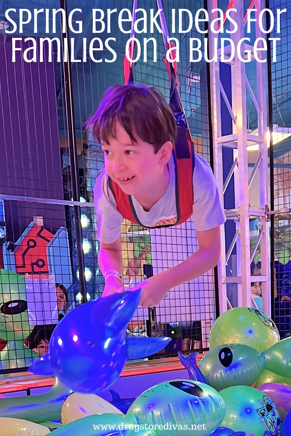 A young boy in a human claw machine with the words 