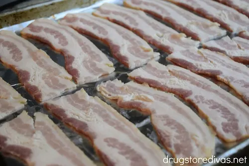 Bacon slices on a foil-lined baking tray.