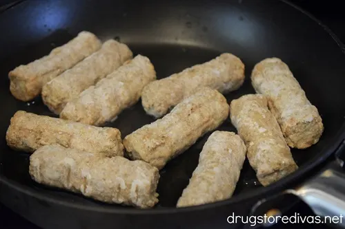 Frozen breakfast sausage links in a skillet.