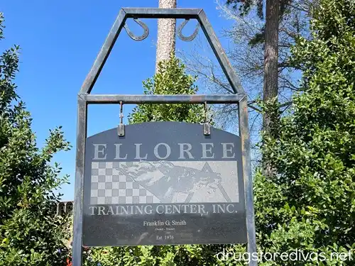 A metal sign with horseshoes on top that says ELLOREE TRAINING CENTER, INC on it.