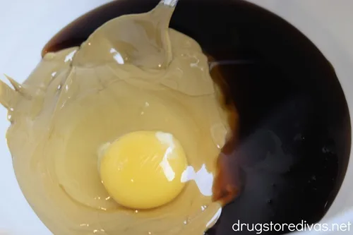 SunButter, maple syrup, and an egg in a white bowl.
