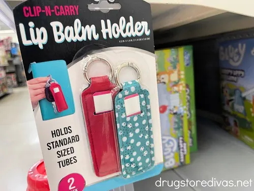 A package of two lip balm holders on a shelf.