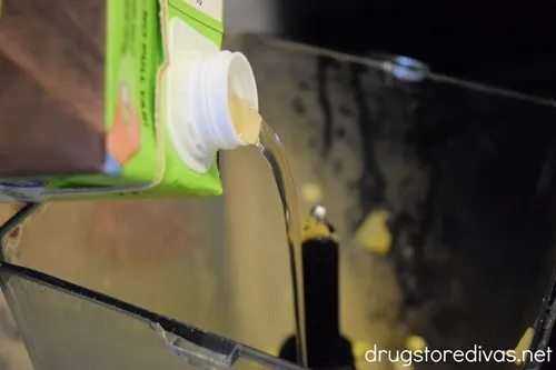 Liquid from a carton being poured into a blender.