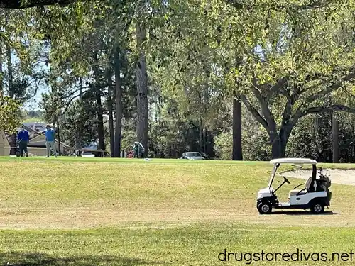 A golf course and golfers on a golf course.