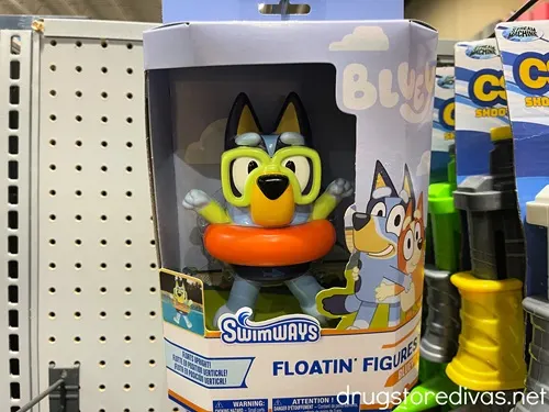 A Bluey Floatin' Figures pool toy in a box on a hanging peg in a store.