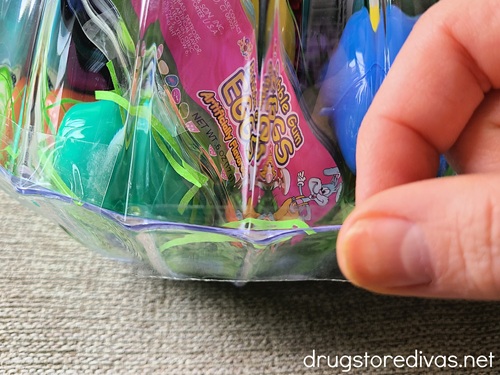 Two plastic bowls, one filled with Easter treats, being taped together.