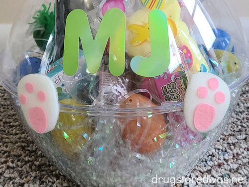 The sticker letters MJ and two foam bunny feet on two bowls that are filled with Easter treats.