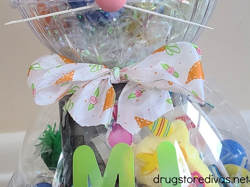 A ribbon bow in the middle of an Easter Bunny gift basket.