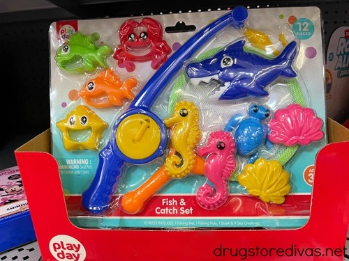 A packaged toy fishing set on a shelf in a store.