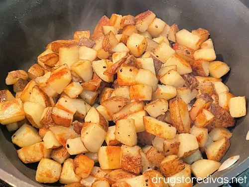 Cooked diced potatoes in a pan.