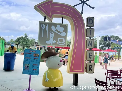 A sign, figure, and arrow advertising a diner at Peppa Pig Theme Park in Winter Haven, Florida.