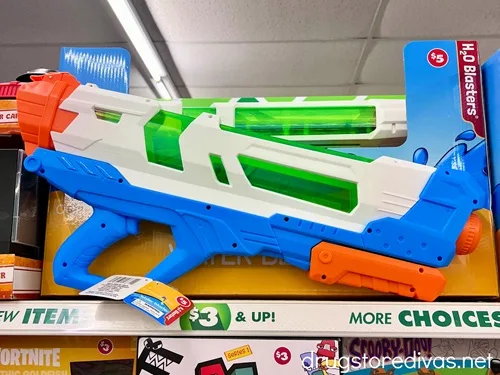 A water gun in a box on a shelf in a store.