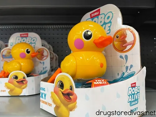 Packs of wind up ducks on a shelf in a store.