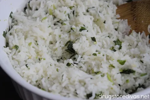 A white, round bowl filled with cilantro lime rice.