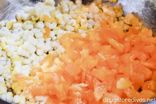 Diced orange bell pepper and corn kernels in a bowl.