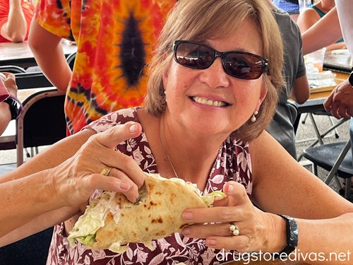 A woman eating a gyro at the Wilmington Greek Festival.