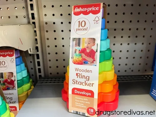 A wooden ring stacker toy in its packaging on a shelf in the store.