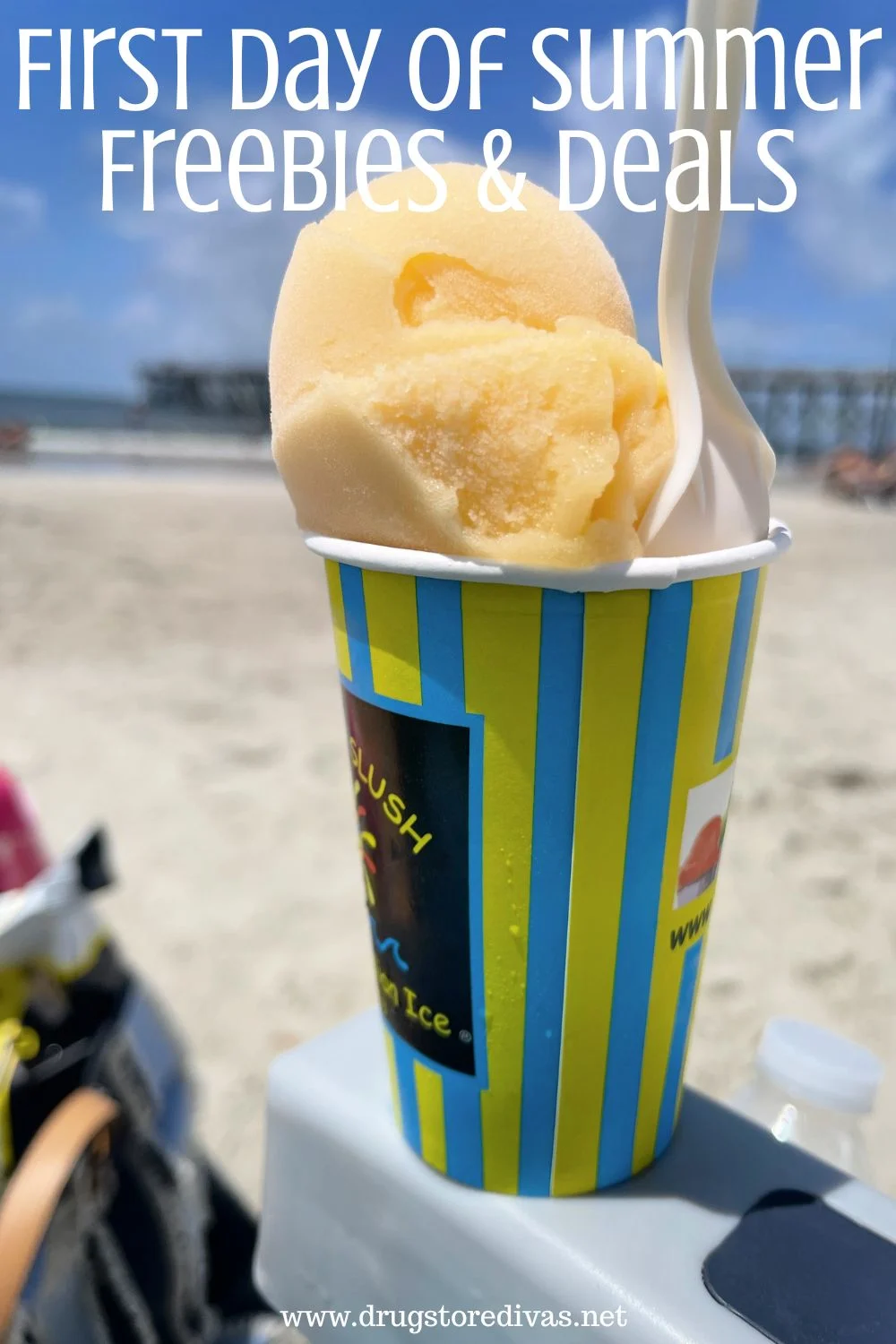 An Italian Ice in a cup with a spoon in it on the side of a chair with the beach and a pier behind it and the words 