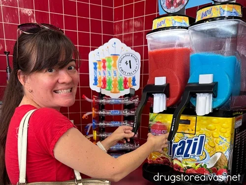 A woman in a red shirt pouring a Frazil slushie.