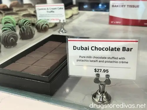 A Dubai chocolate bar at Hampton Chocolate Factory with a sign next to it with a price tag of $27.95.