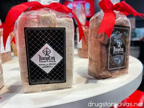 Packs of marshmallows with red ties on the top on a white shelf for sale in Hampton Chocolate Factory in Tampa, Florida.